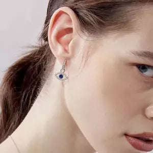 Image of a lady wearing evil eye earrings
