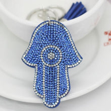 Load image into Gallery viewer, Light Blue Stone Studded Hamsa Hand with Evil Eye Keychain - Keychain
