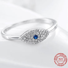 Load image into Gallery viewer, Image of a white Evil Eye ring in a sparkling blue and white stone-studded eye-shaped Evil Eye
